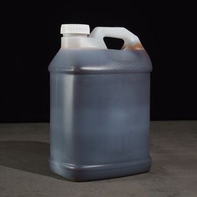 A gallon of black liquid with a white cap