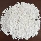 A pile of white powder is sitting on top of a wooden table.