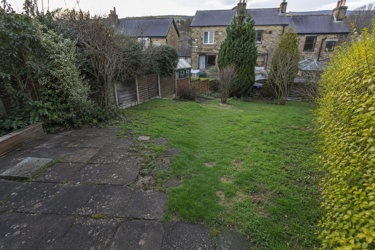 Aged resin driveway with cracks before resurfacing