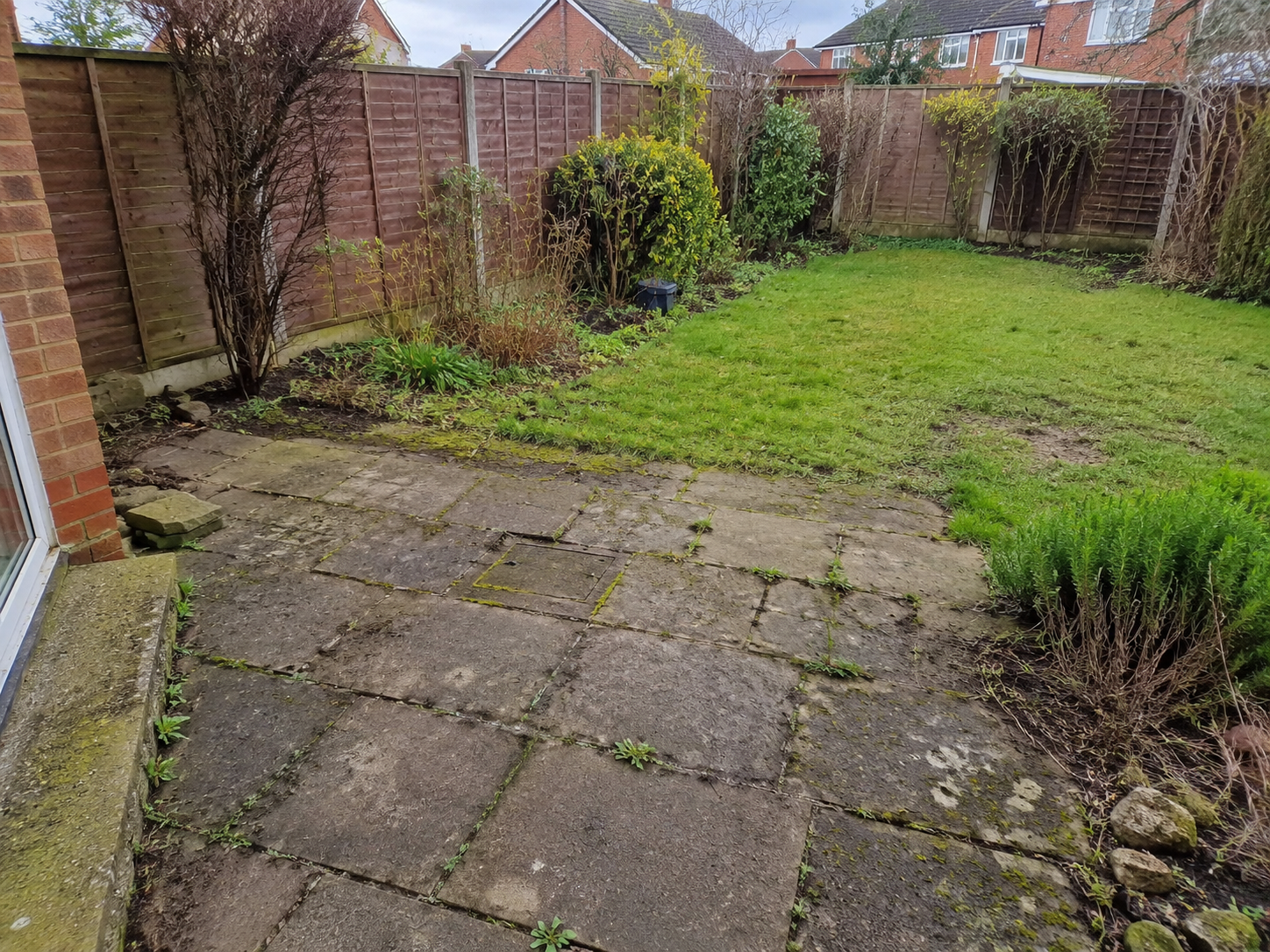 Aged resin driveway with cracks before resurfacing
