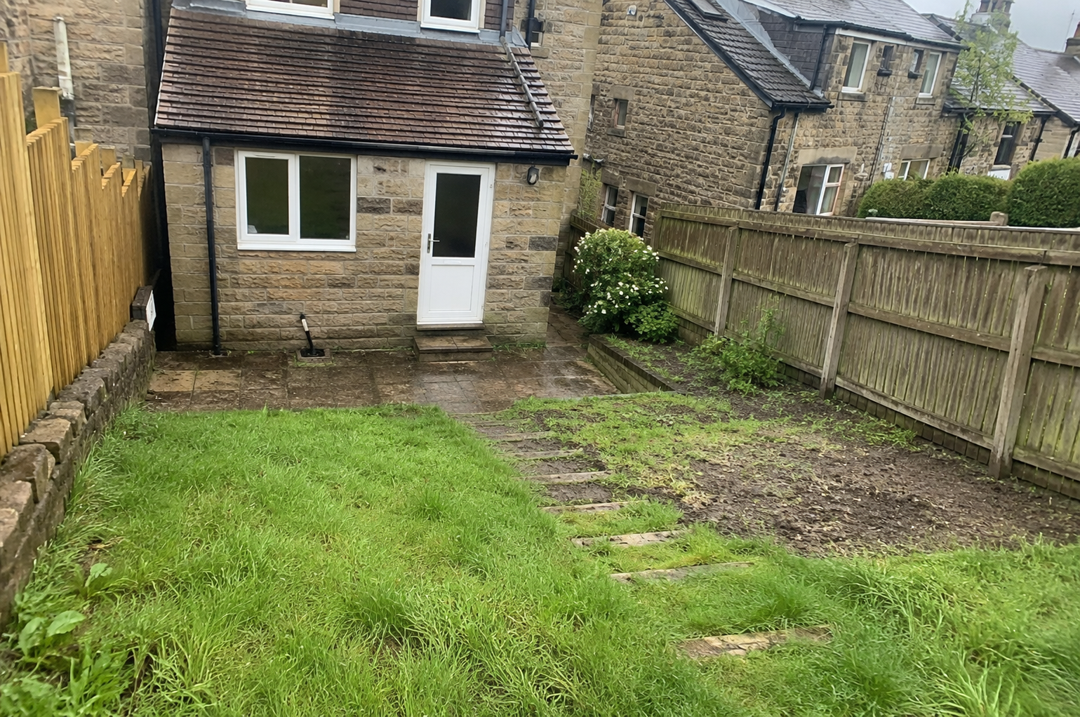 Aged resin driveway with cracks before resurfacing