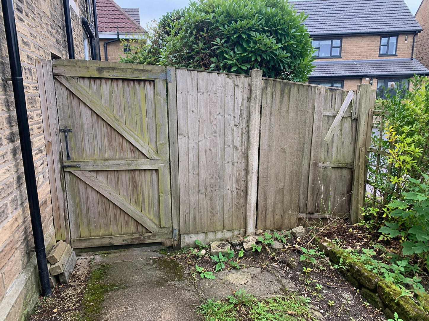 Aged resin driveway with cracks before resurfacing