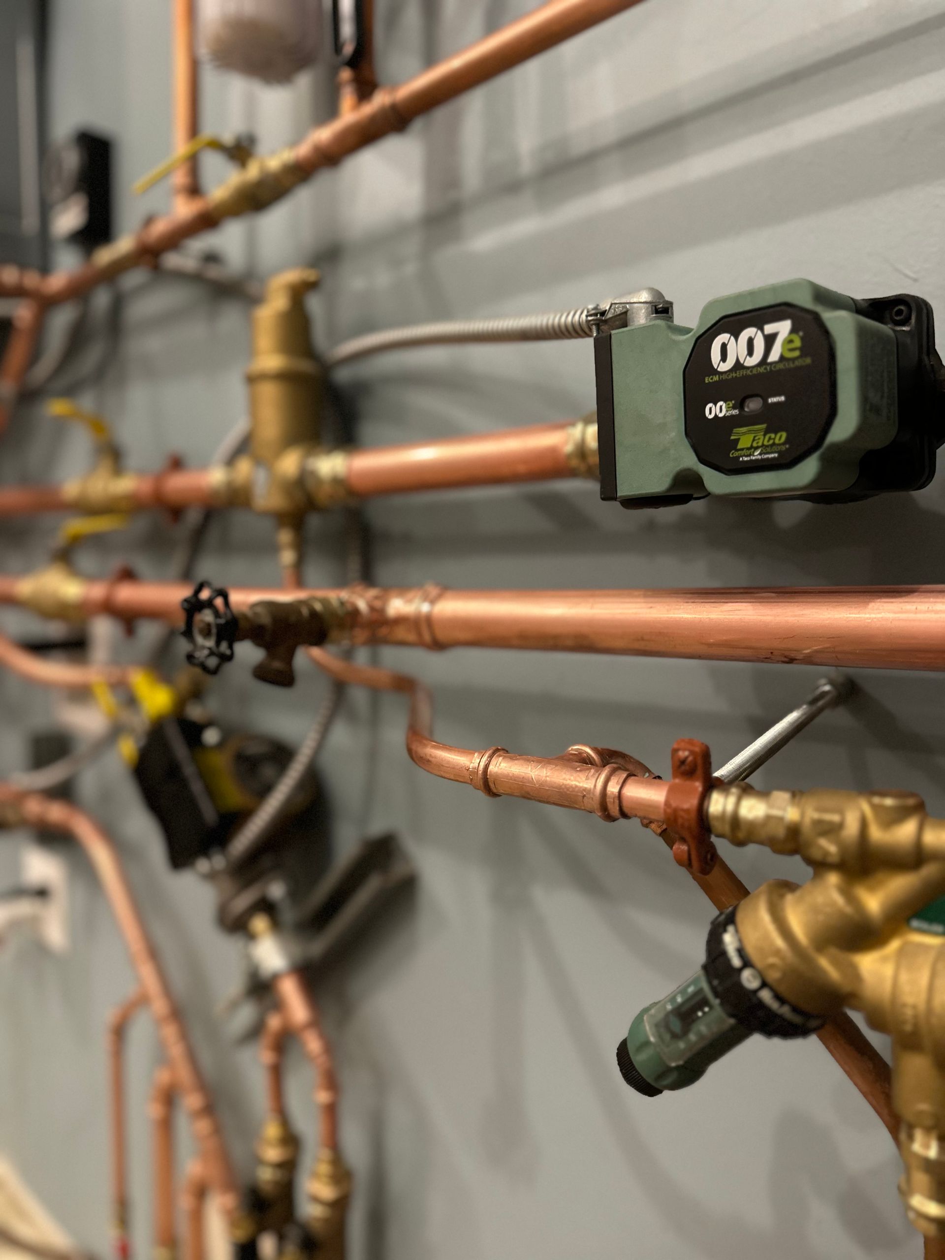 A copper pipe with a valve that says 007 on it