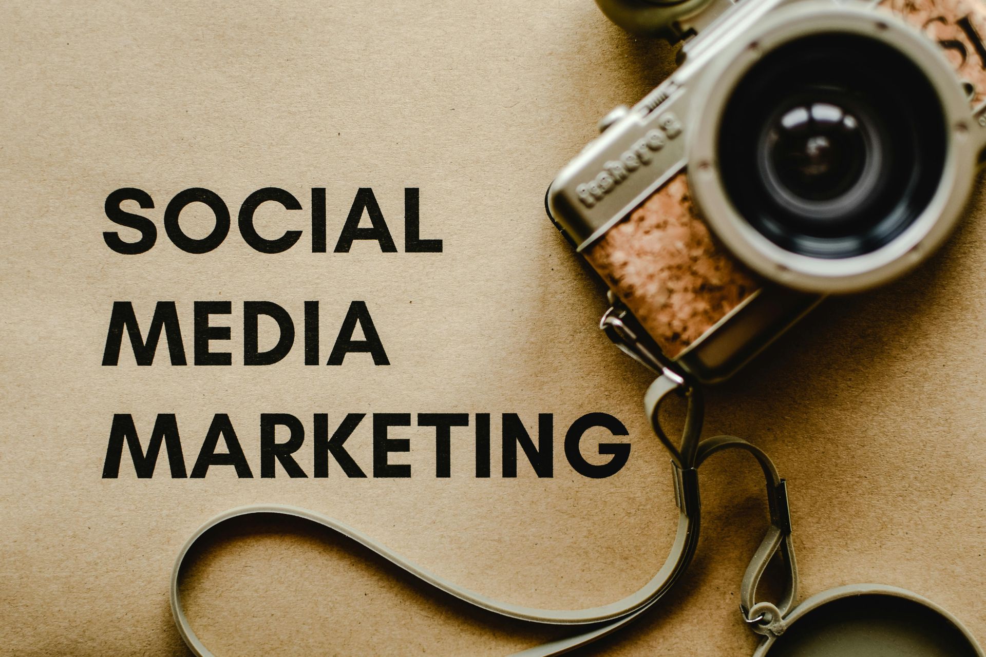 A camera with the words Social Media Marketing displayed on the side, symbolizing the connection between visual content and digital marketing. A camera with the words Social Media Marketing displayed on the side, symbolizing the connection between visual content and digital marketing.