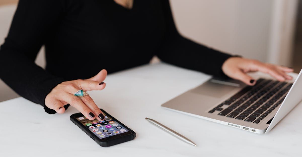 SEO professional working on a smartphone and laptop SEO professional working on a smartphone and laptop