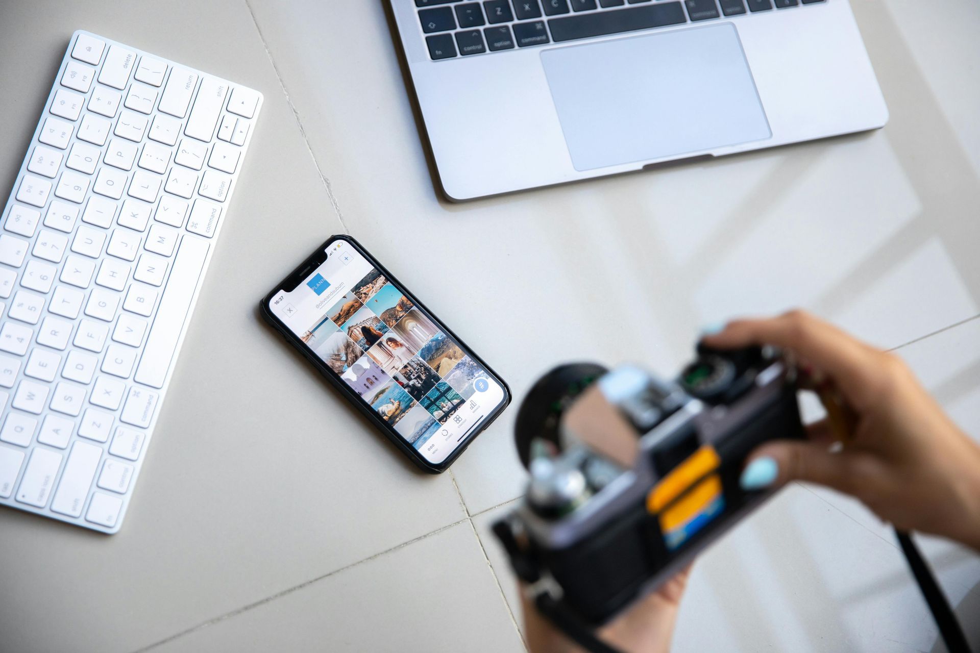 professional takes a picture of a phone, keyboard and laptop professional takes a picture of a phone, keyboard and laptop