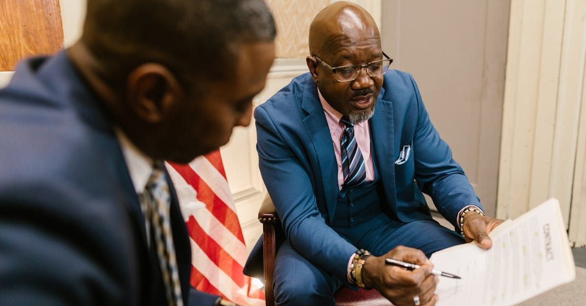 Two professionals focused on discussing a legal document and strategizing on effective law firm marketing with the use of social media. Two professionals focused on discussing a legal document and strategizing on effective law firm marketing with the use of social media.