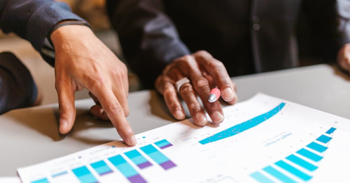 Two professionals discussing SEO strategy over a printed analytics report.