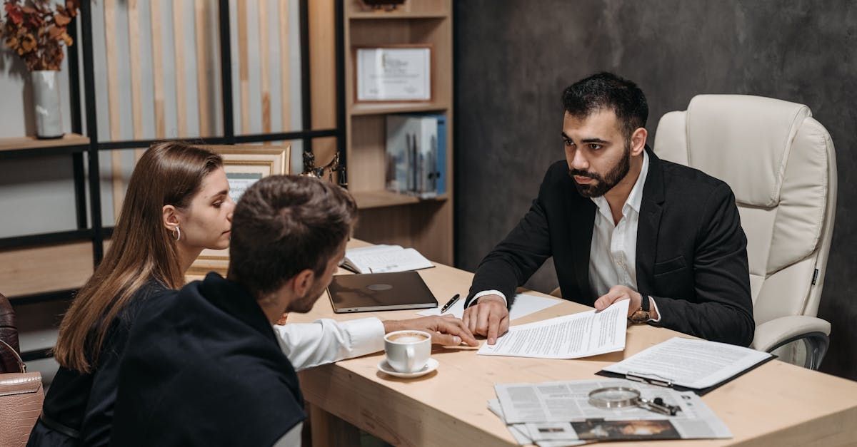 Clients and lawyer discussing legal matters in a professional setting. Clients and lawyer discussing legal matters in a professional setting.