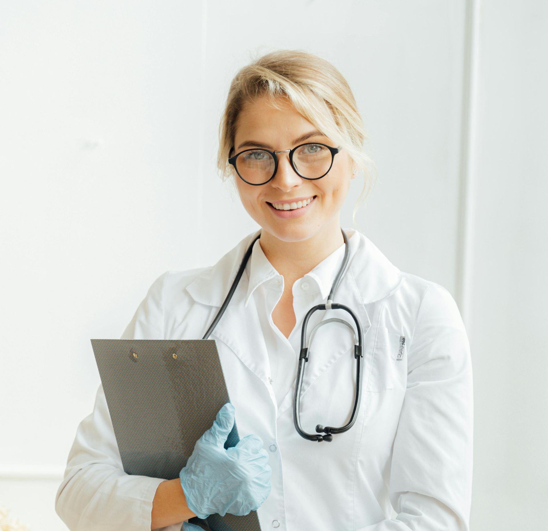 healthcare professional holding a clipboard, ready to assist a patient.