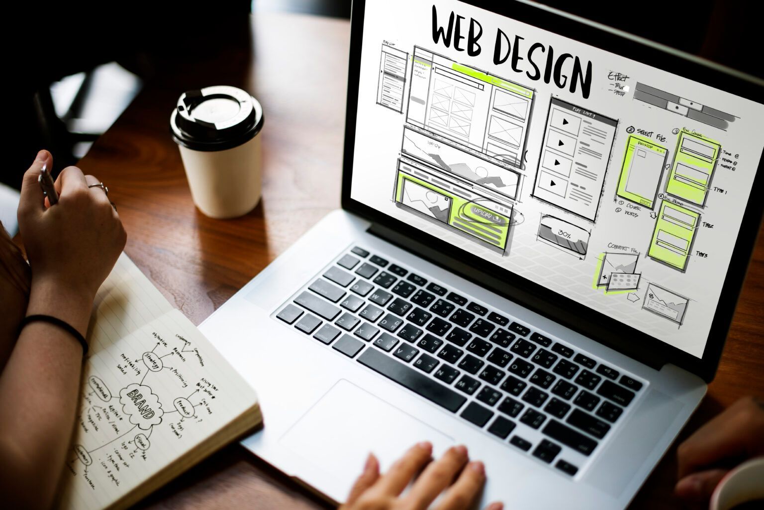 professional working on a laptop with web design displayed on the screen professional working on a laptop with web design displayed on the screen