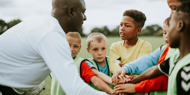 Soccer coach instructing player during a game