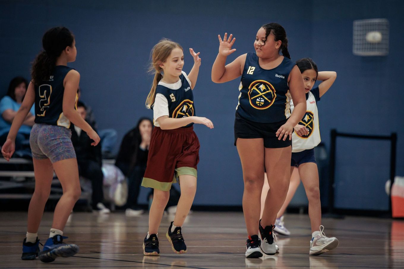 Youth basketball players celebrating