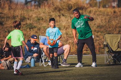 Soccer coach instructing player during a game