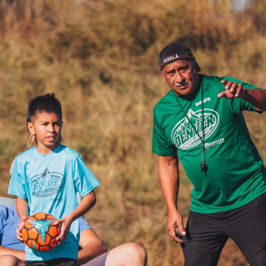 Soccer coach instructing player during a game