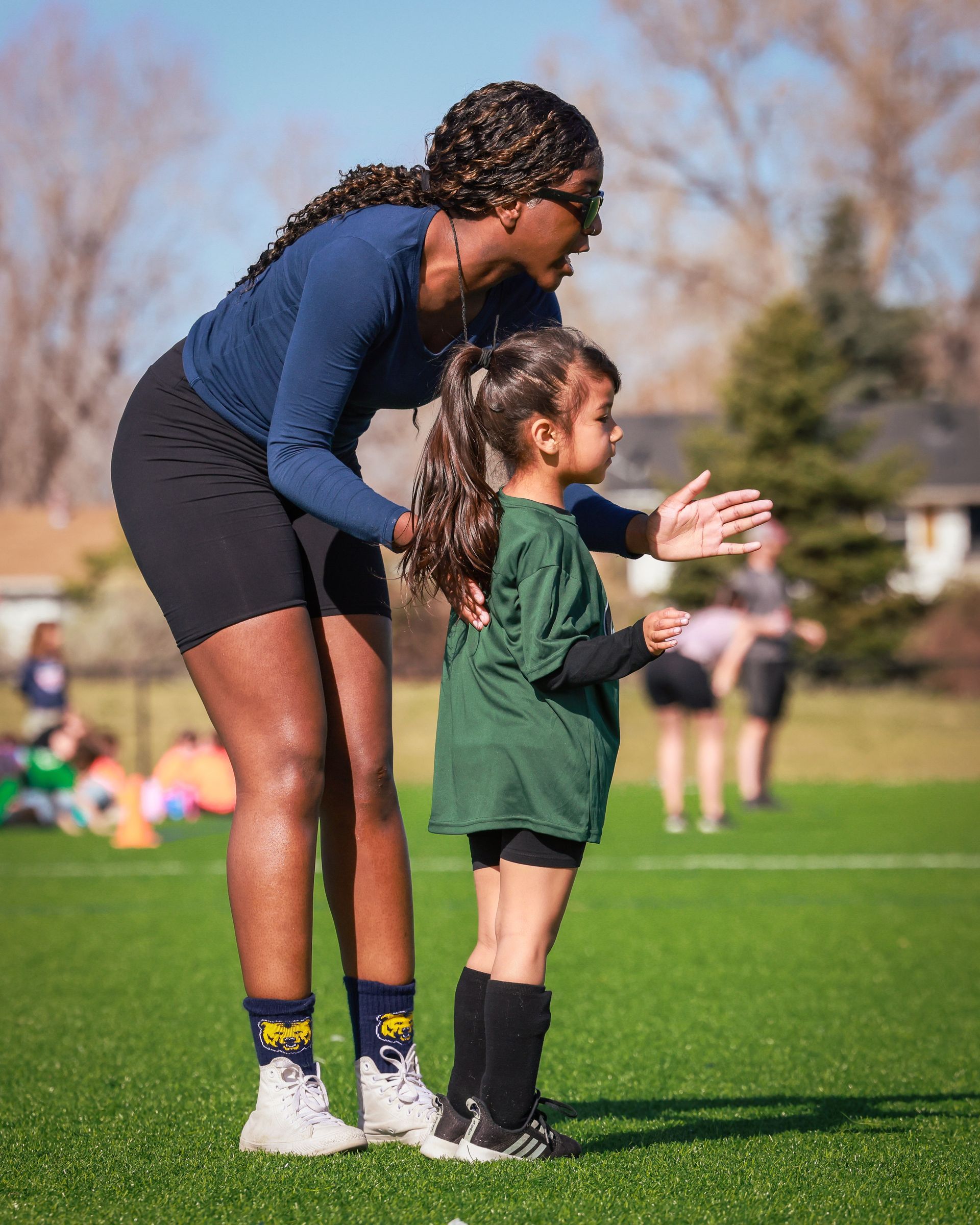 Soccer coach instructing player during a game