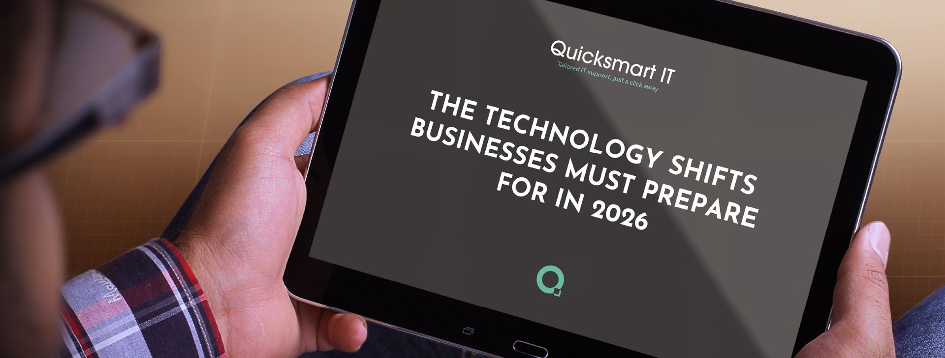 Person holding a tablet displaying text about technology shifts businesses should prepare for in 2026.