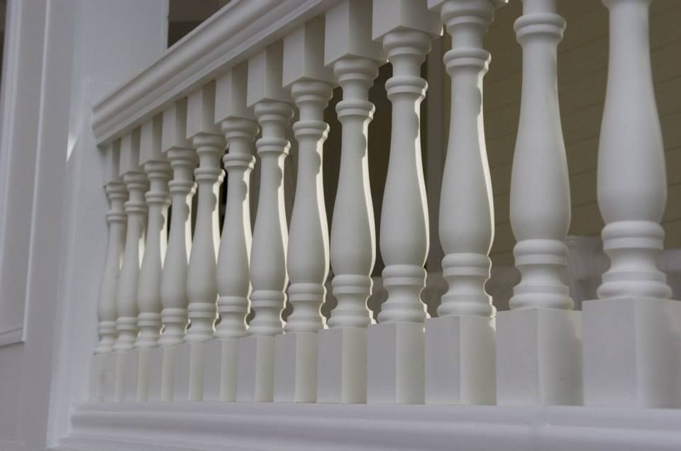 A close up of a white railing on a balcony
