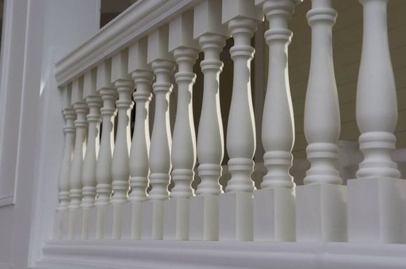 A close up of a white railing on a balcony