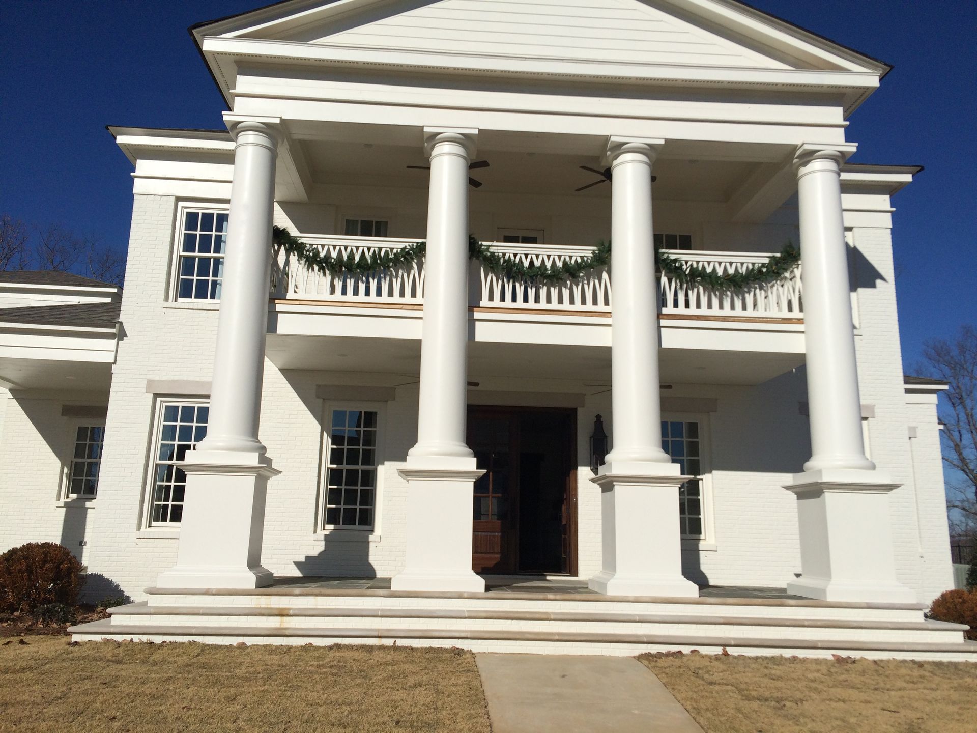A large white house with columns and a balcony