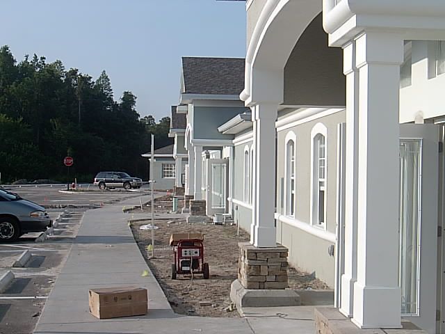 A row of houses under construction with boxes on the sidewalk