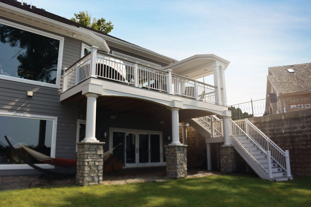 A large house with a large deck and stairs