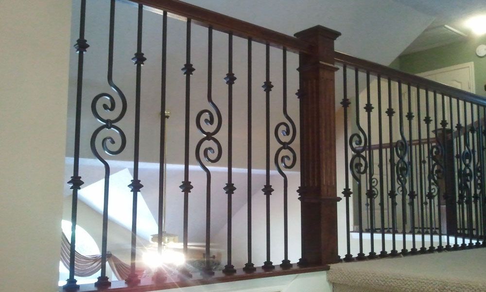 A wrought iron railing on a staircase in a house