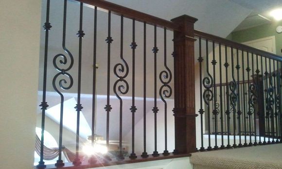 A wrought iron railing on a staircase in a house