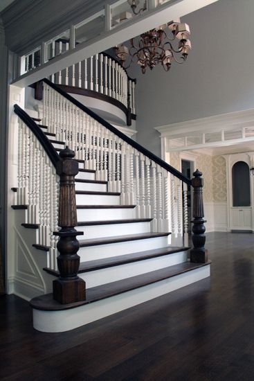 A staircase with a chandelier hanging from the ceiling