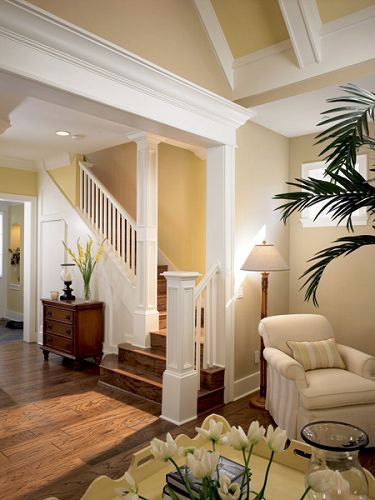 A living room with a staircase leading up to the second floor