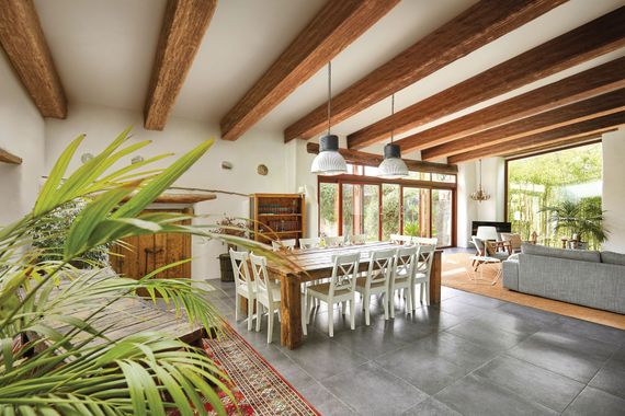 A large living room with a dining table and chairs