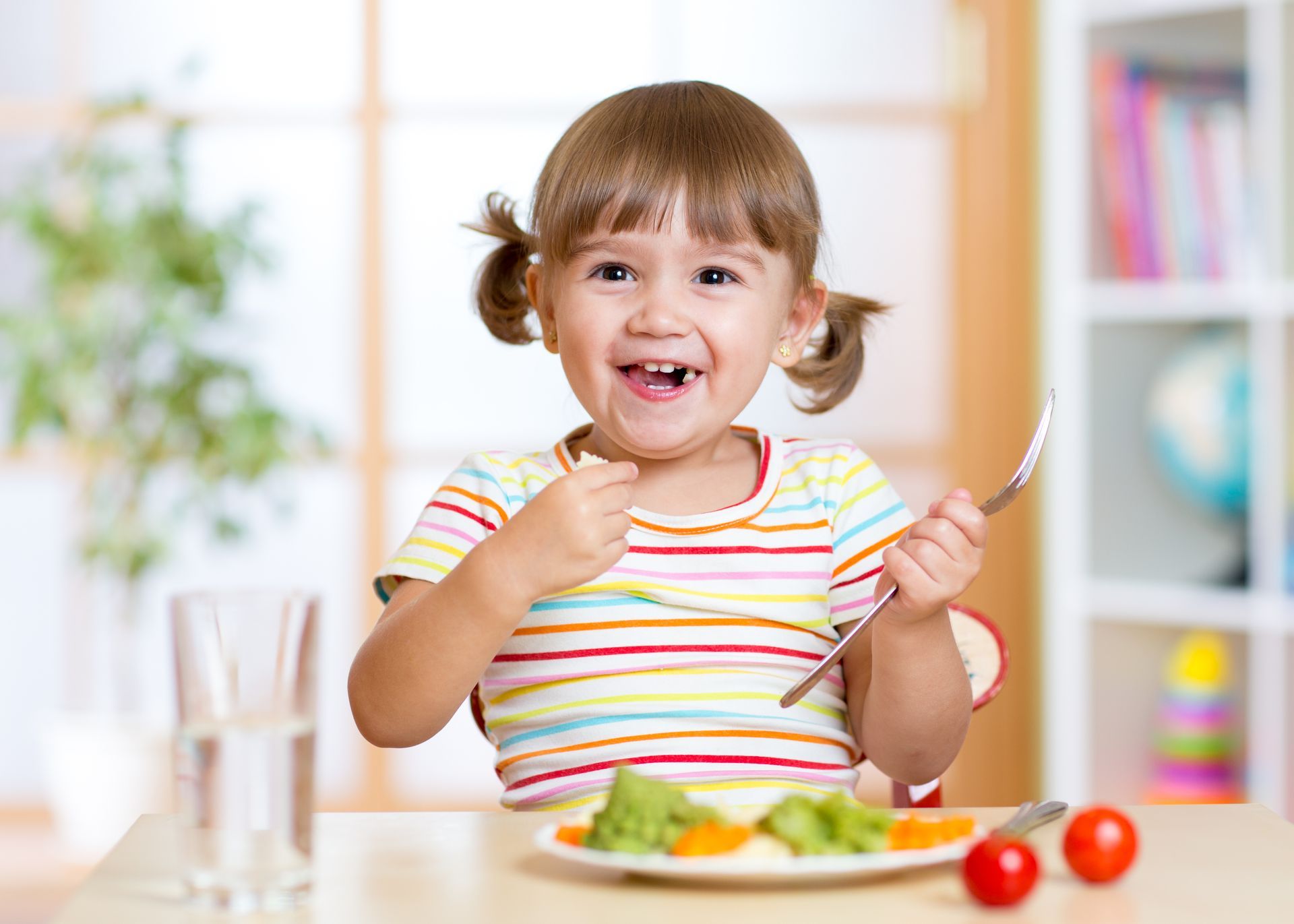 Happy toddler girl enjoying mealtime — Picky Eater Parenting course helps build positive food experiences