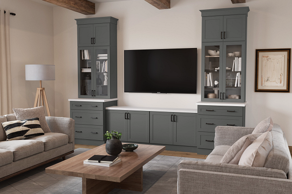 Modern living room with gray built-ins, wall-mounted TV, beige sofas, and a wooden coffee table