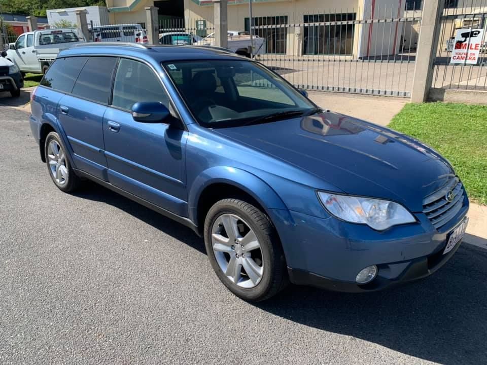 A Blue Subaru Outback Station Wagon Is Parked On The Side Of The Road — Downsy's Cars In Bentley Park, QLD