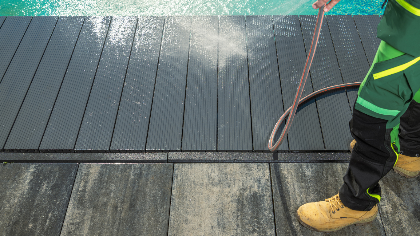 Power washing a pool deck surface