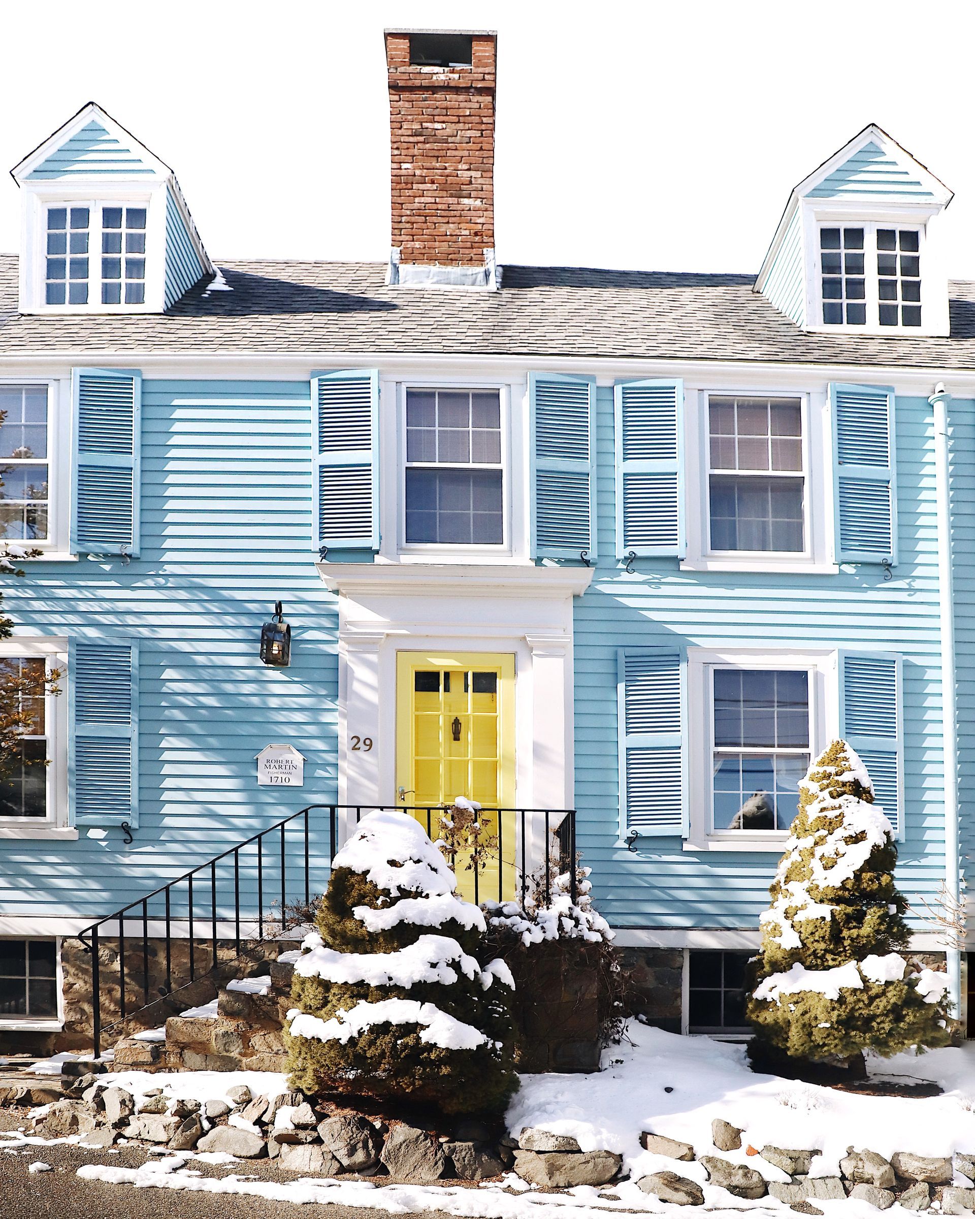 Blue historic Hotel Marblehead building with white trim and a roof tower
