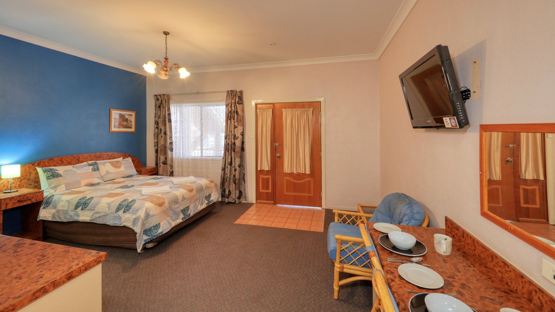 Hotel Room with A Bed, Table with Place Settings, Tv, and Doorway — Townview Motel In Mount Isa, QLD
