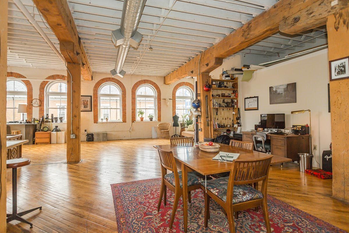 A large room with a table and chairs in it.