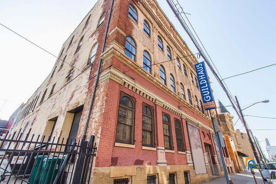A large brick building with a sign that says guildhaus