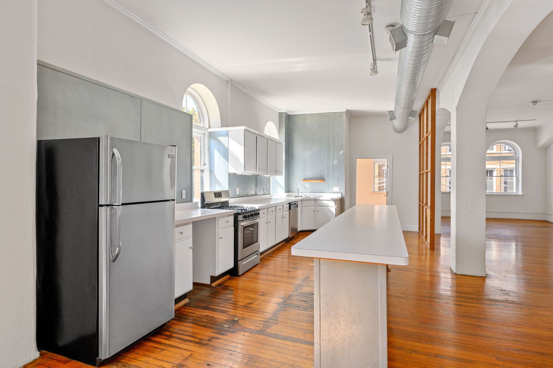 A kitchen with a refrigerator , stove , and sink.