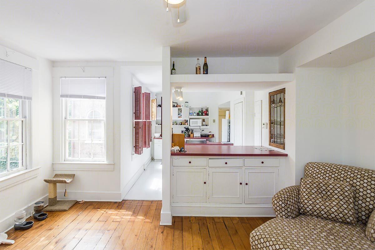A living room with hardwood floors and a couch