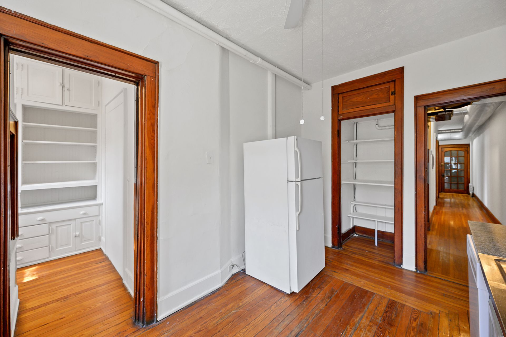 There is a refrigerator in the middle of the room.