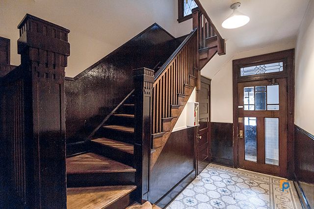 A wooden staircase leading up to the second floor of a building.