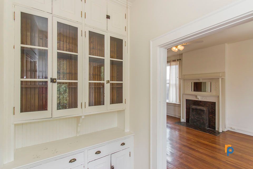 There is a fireplace in the corner of the room.