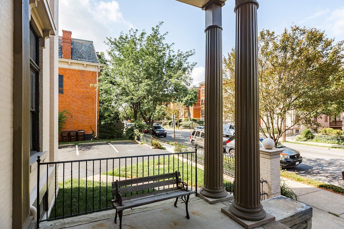 There is a bench on the porch of a house.