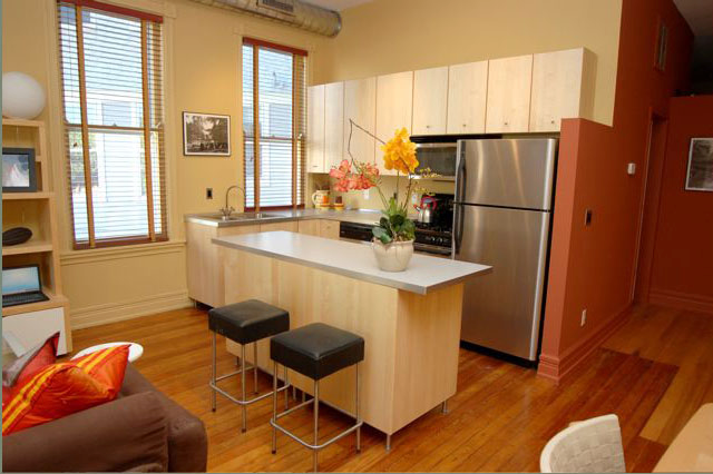 A kitchen with stainless steel appliances and a large island