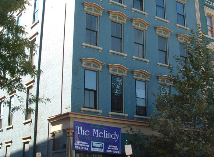 A blue building with a blue sign that says the mclindy