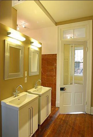 A bathroom with two sinks and two mirrors