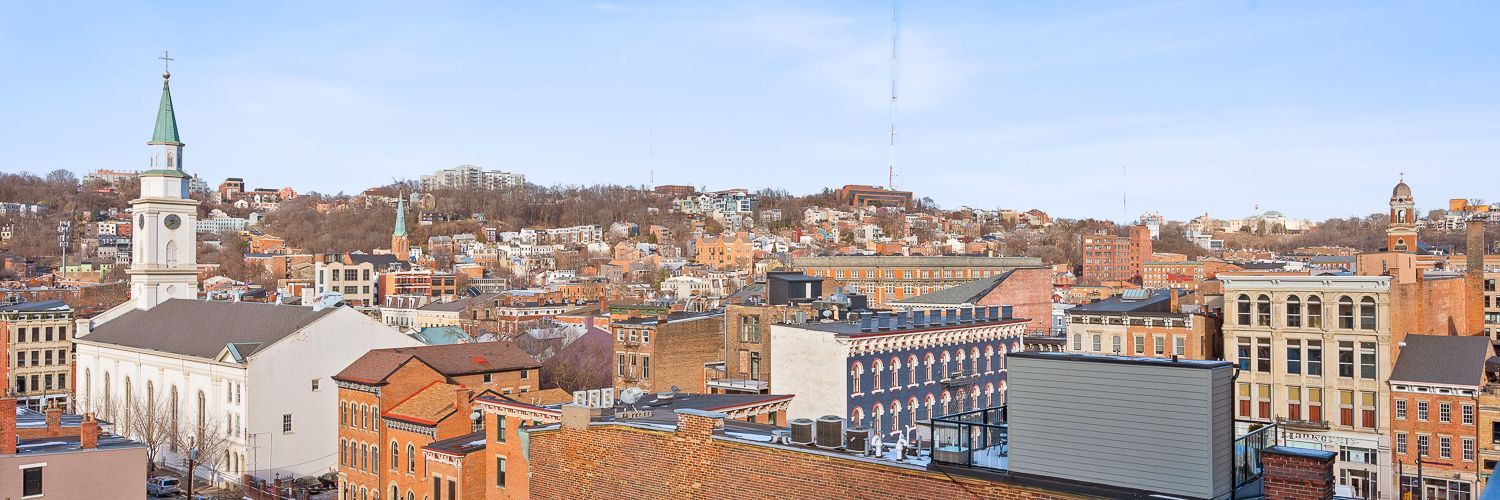 An aerial view of a city with a clock tower in the background.