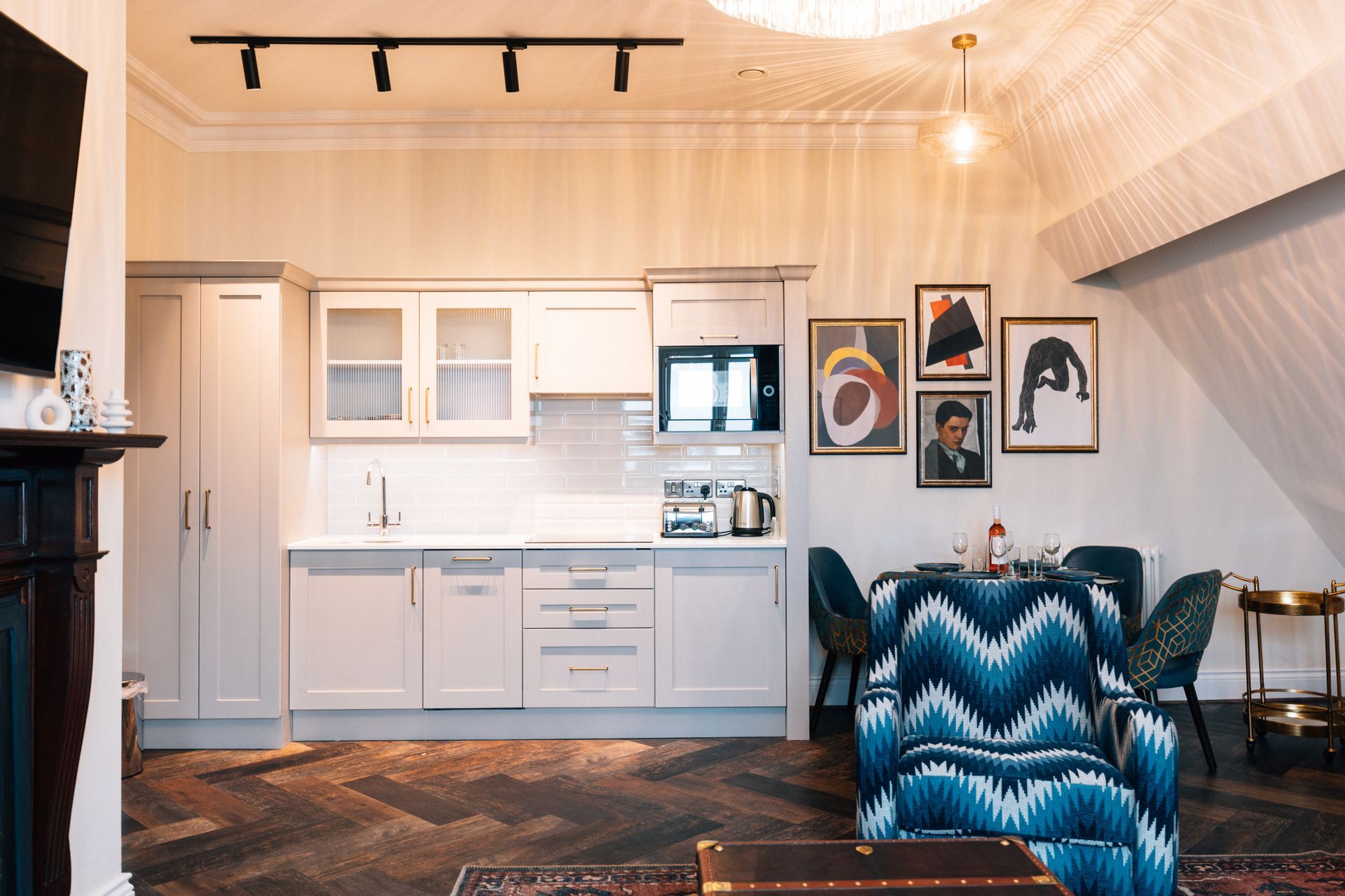Cozy apartment interior with a small kitchen, dining area, and seating. 